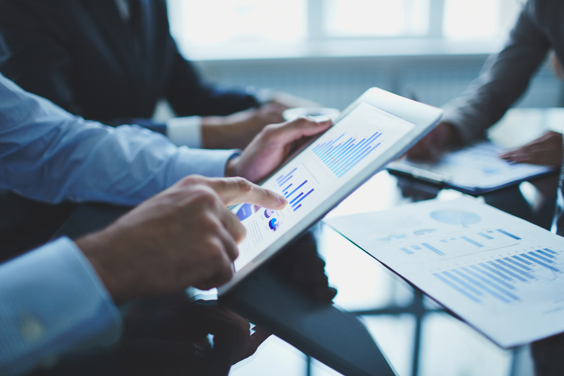 Founders reviewing financial dashboards and KPI reports on a tablet during a startup finance review